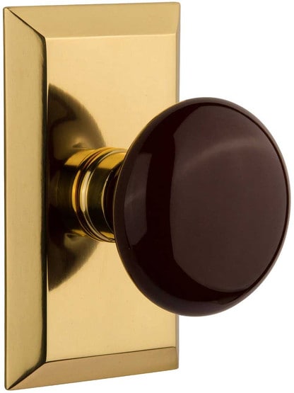 New York Rosette Door Set with Brown Porcelain Knobs in Polished Brass.